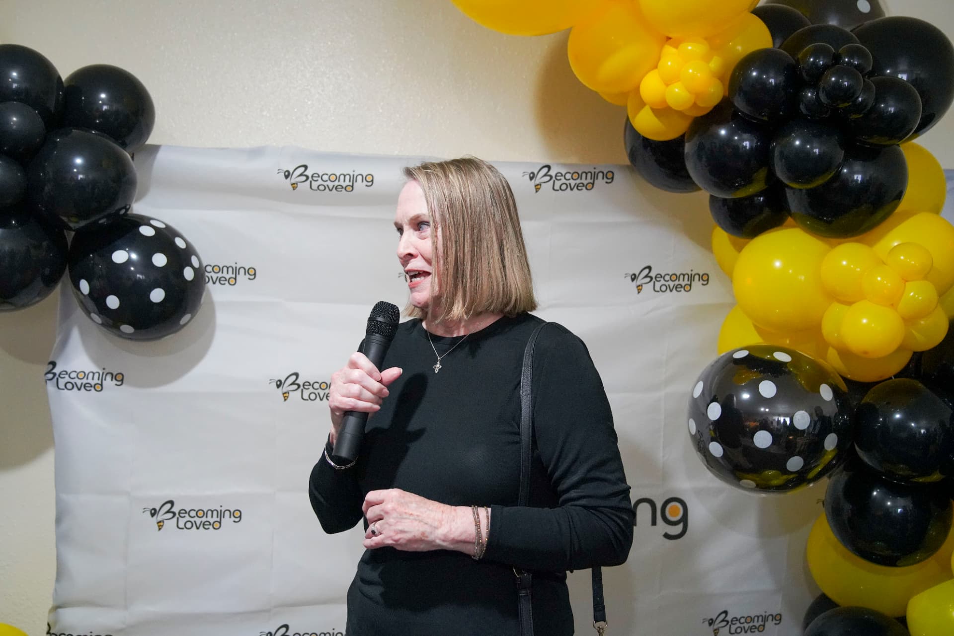 An attendee speaking into a microphone at the celebration