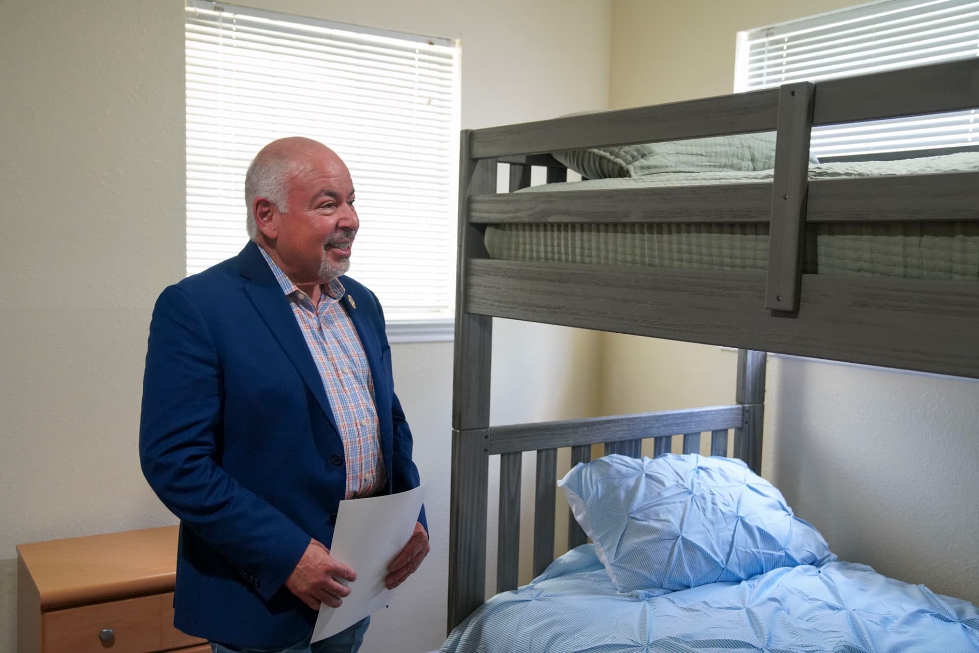 An attendee viewing a room with bunk beds during a tour of the home
